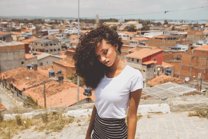 mujer con camisa blanca de pie al aire libre