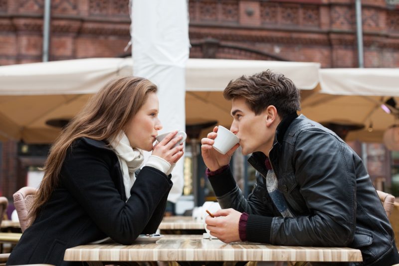 young couple drinking coffee outdoor