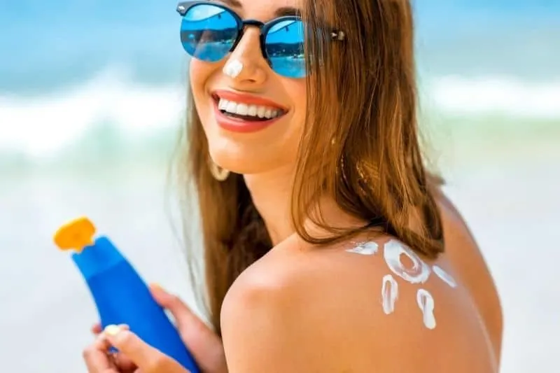 young woman with a sunscreen shaped with a sun on the shoulder