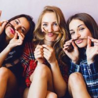 three female friends having fun with an indoor picture taking