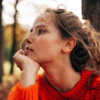 young pensive woman looking away