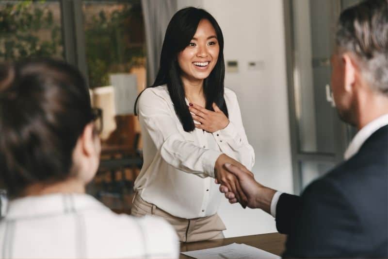asian woman handshaking a business people for a career placement concept