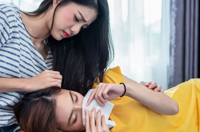 best friend comforting woman crying lying down on her lap