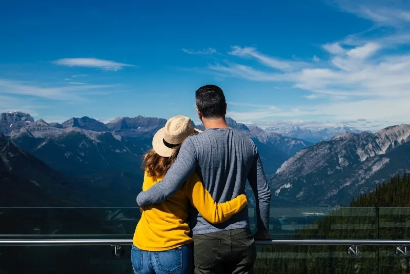 man and woman hugging while looking at mountain