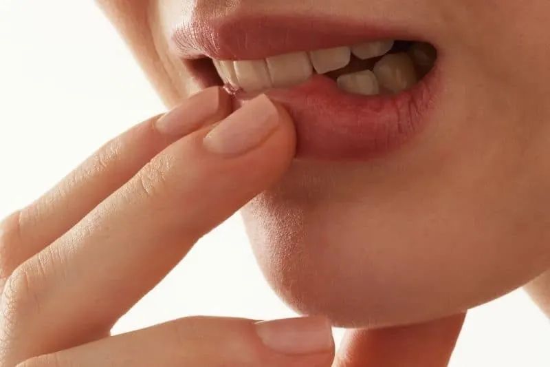 cropped image of a lip bitten indicating shyness 