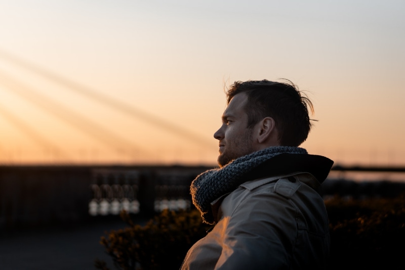 man with scarf standing outdoor