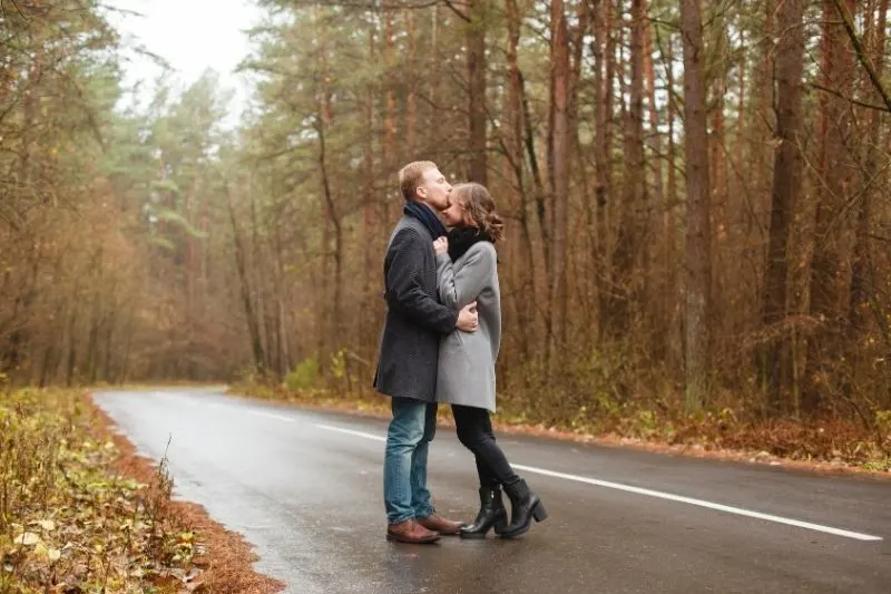 romantic couple standing in the middle of an empty road