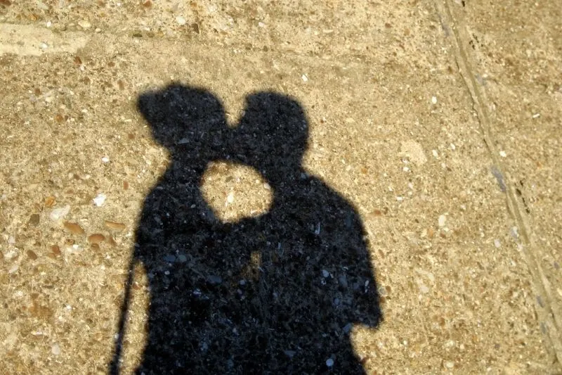 shadow of a couple kissing in the pedestrian street