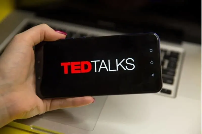 ted talks logo shown on the smartphone held by a woman cropped