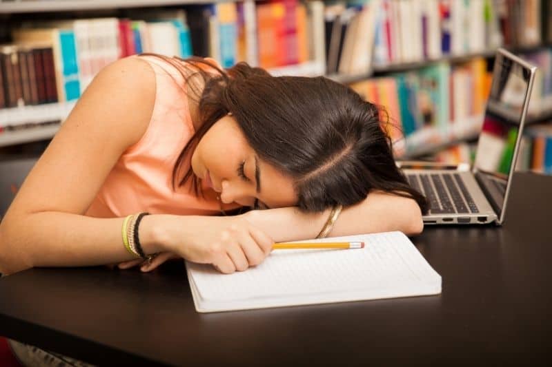 too much homework done by a brunetter woman fell asleep in the library 