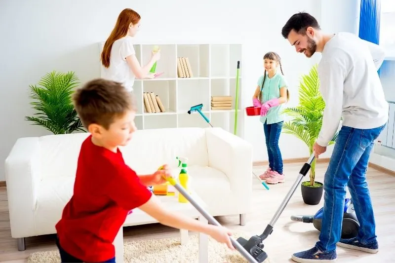 whole family cleaning the living room intensively