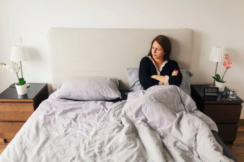 wife waiting for husband while lying in bed in the morning