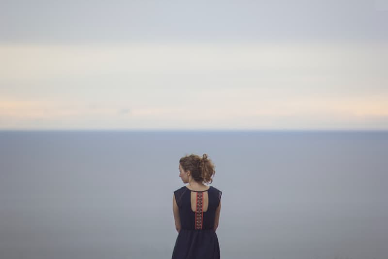 woman looking at the left while standing near sea