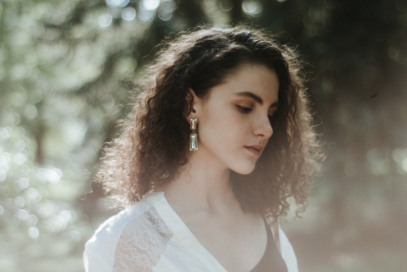 woman with curly hair standing outdoor