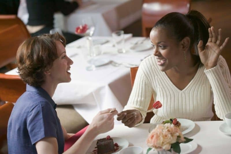 women eating at the restaurant while chatting