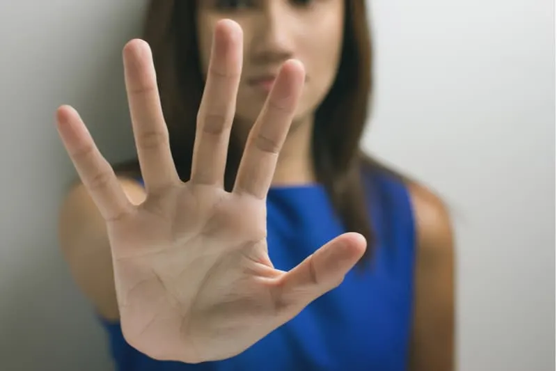 young woman showing her denial with her hand in focus