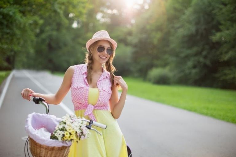 smiling woman holding a bike