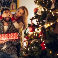 Beautiful girl surprising her boyfriend with a present.