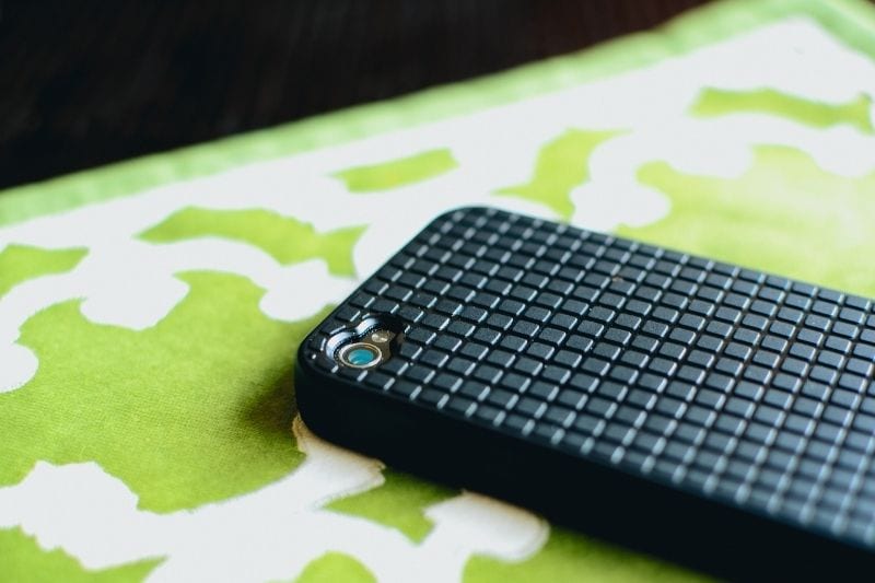 back of the cellphone face down on the table with checkered pattern case