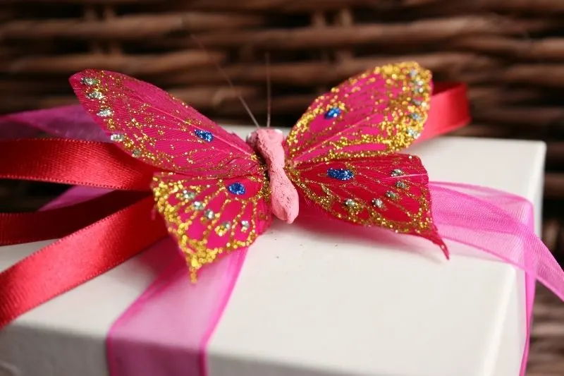 birthday gift with butterfly ribbon glittered with different colors