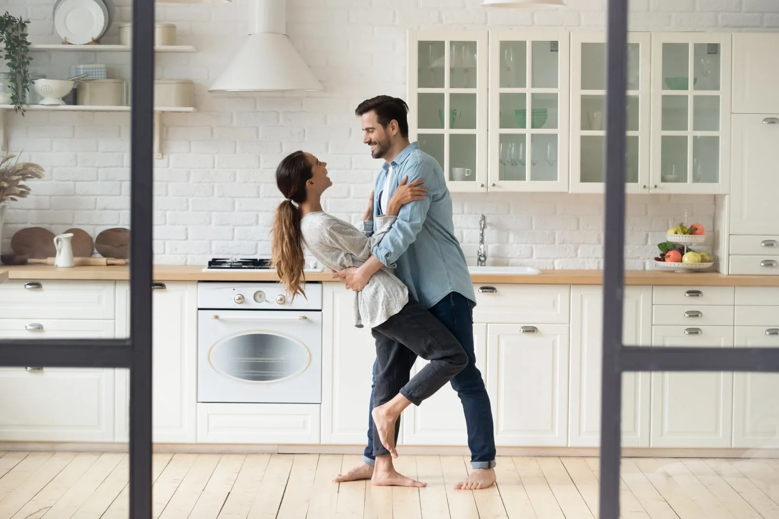 couple dance together in the kitchen