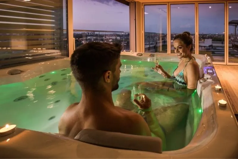 couple inside bathtub drinking wine inside the hotel