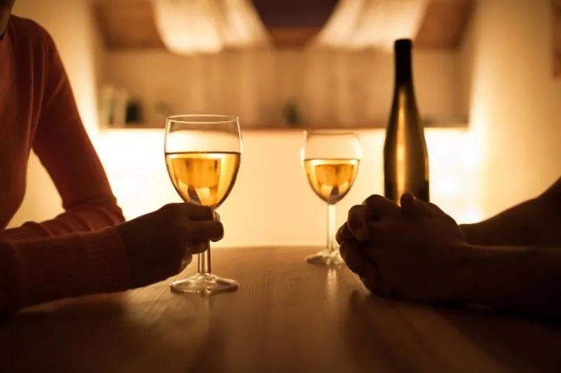 couple sitting together in dinner date with a wine