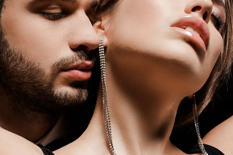 cropped image of a bearded man near a seductive woman 