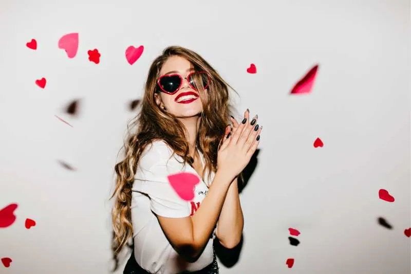 easy going girl expressing positivity with confetti of hearts