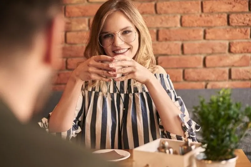 first date with a cup of coffee inside a cafe between a man and a woman
