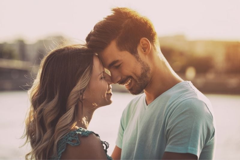 intentionally toned image of a sweet couple standing near the body if water