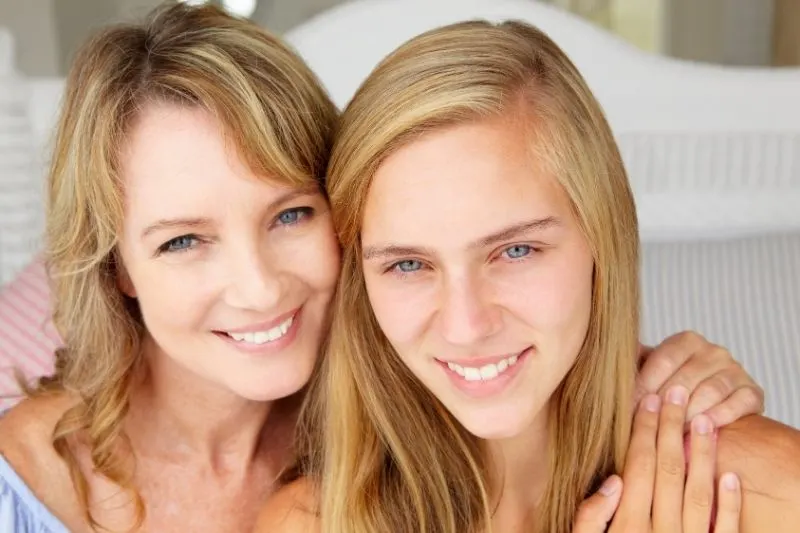 mother with teen daughter with focus on their faces