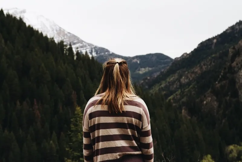 woman in striped top looking at mountain
