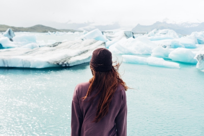 woman in purple shirt looking at water