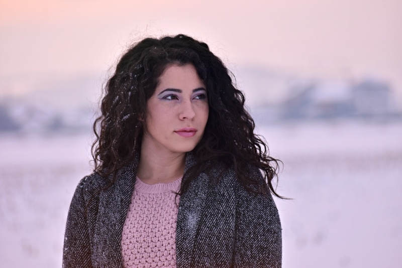 woman in gray coat standing outdoor