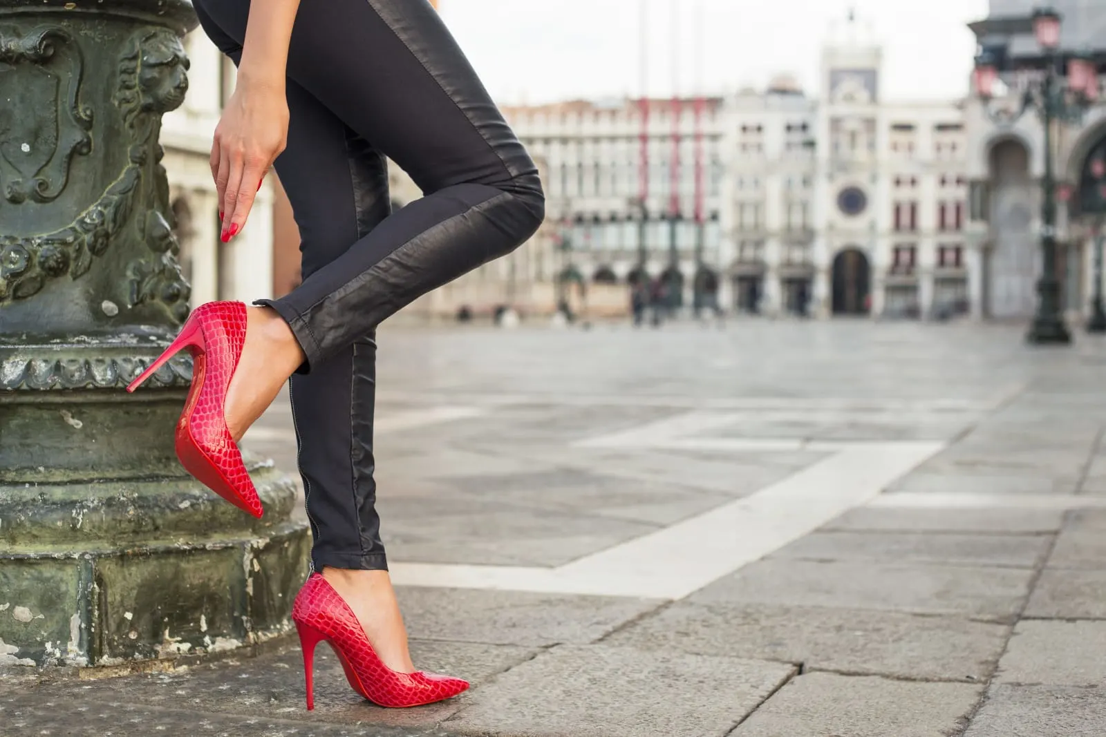 woman wearing black pants and red heels