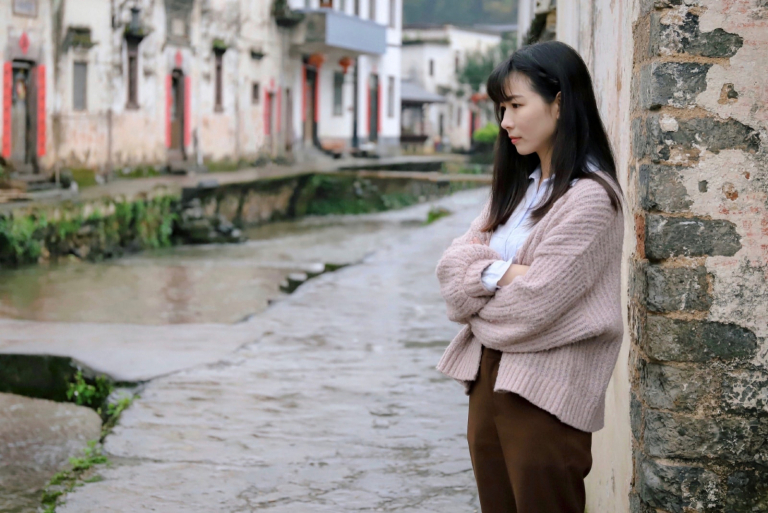 angry woman standing near wall