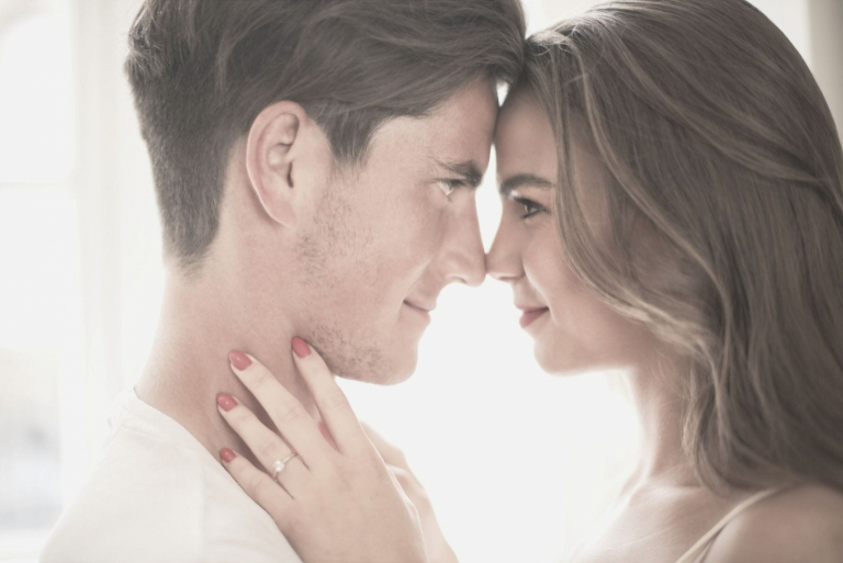 young couple having intimate moment with head close to each other