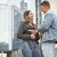 man and woman talking while standing outdoor