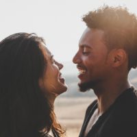 man and woman making eye contact while sitting outdoor