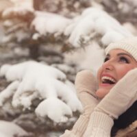 beautiful smiling brunette enjoys a snowy idyll