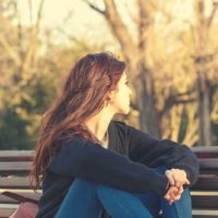 woman sitting on a park bench