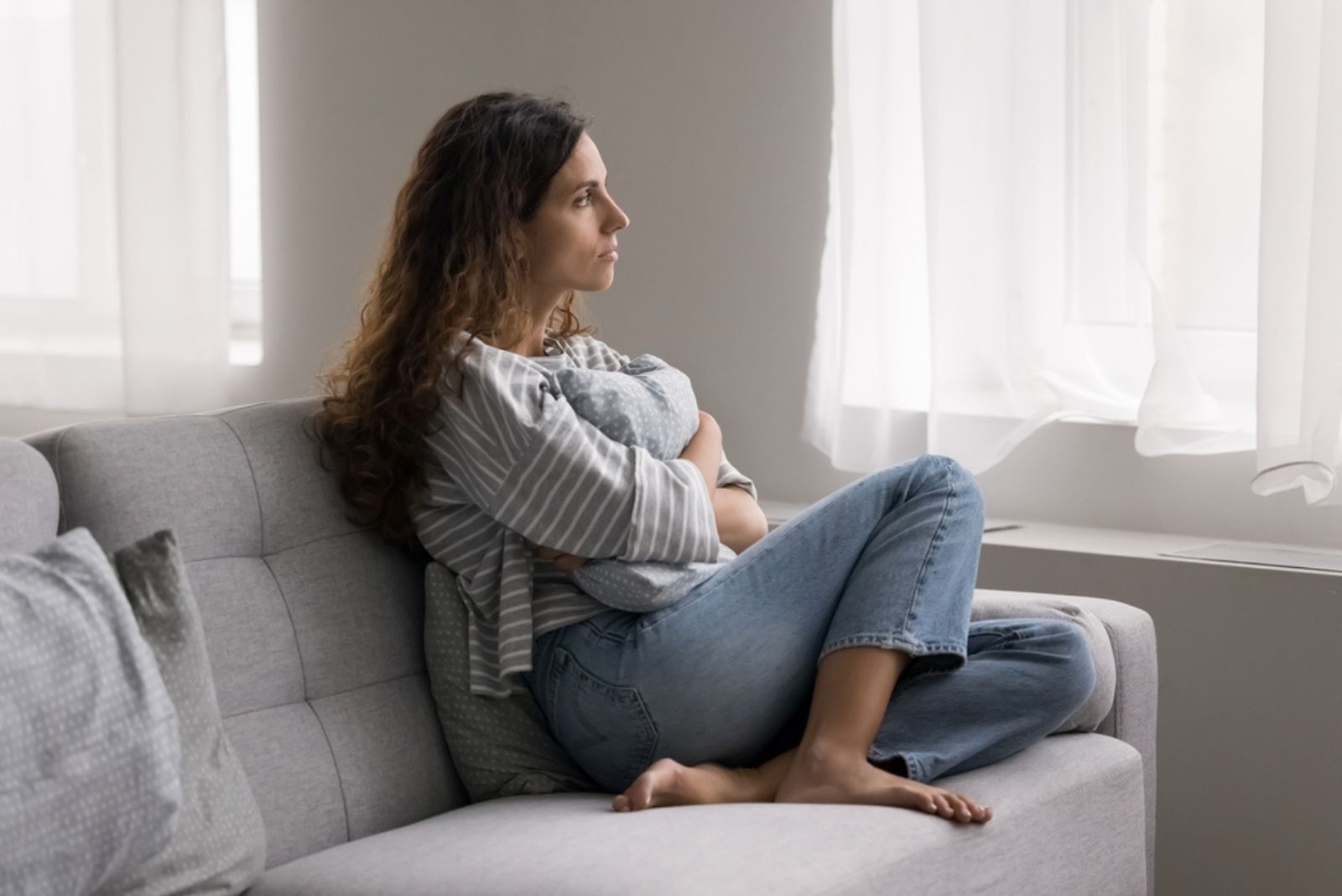 mujer seria sentada en el sofá