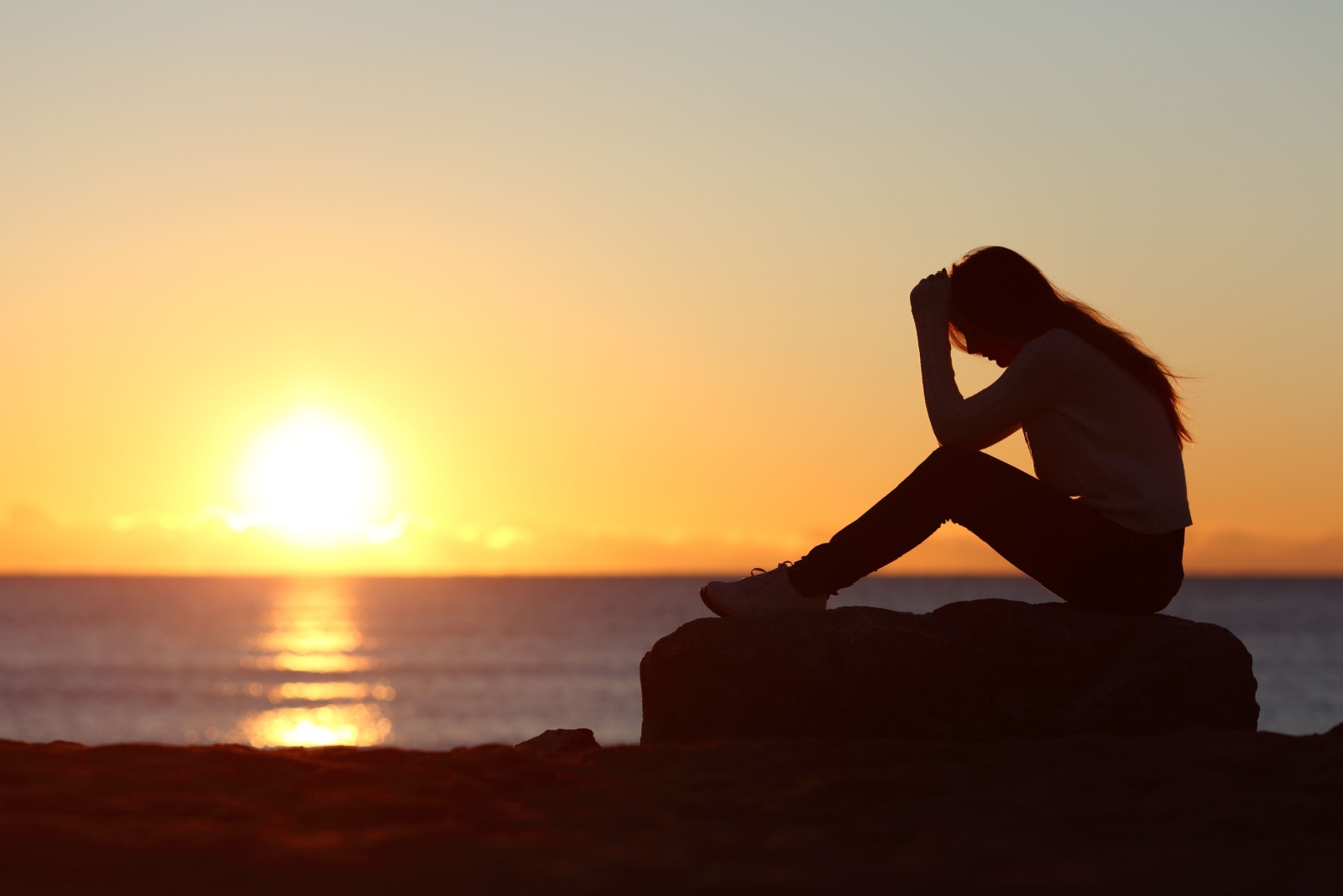 lonely woman by the ocean