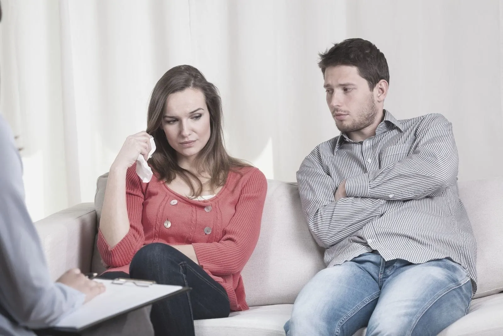 couple before divorce at the psychotherapy office with a counsellor in front of them