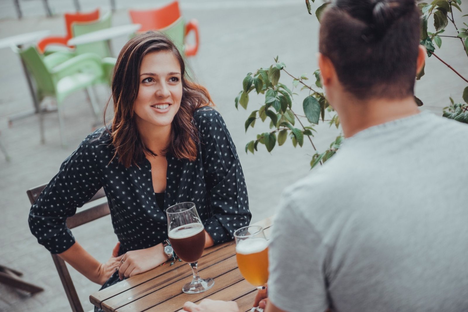 couple drinking outdoors beer and talking seriously