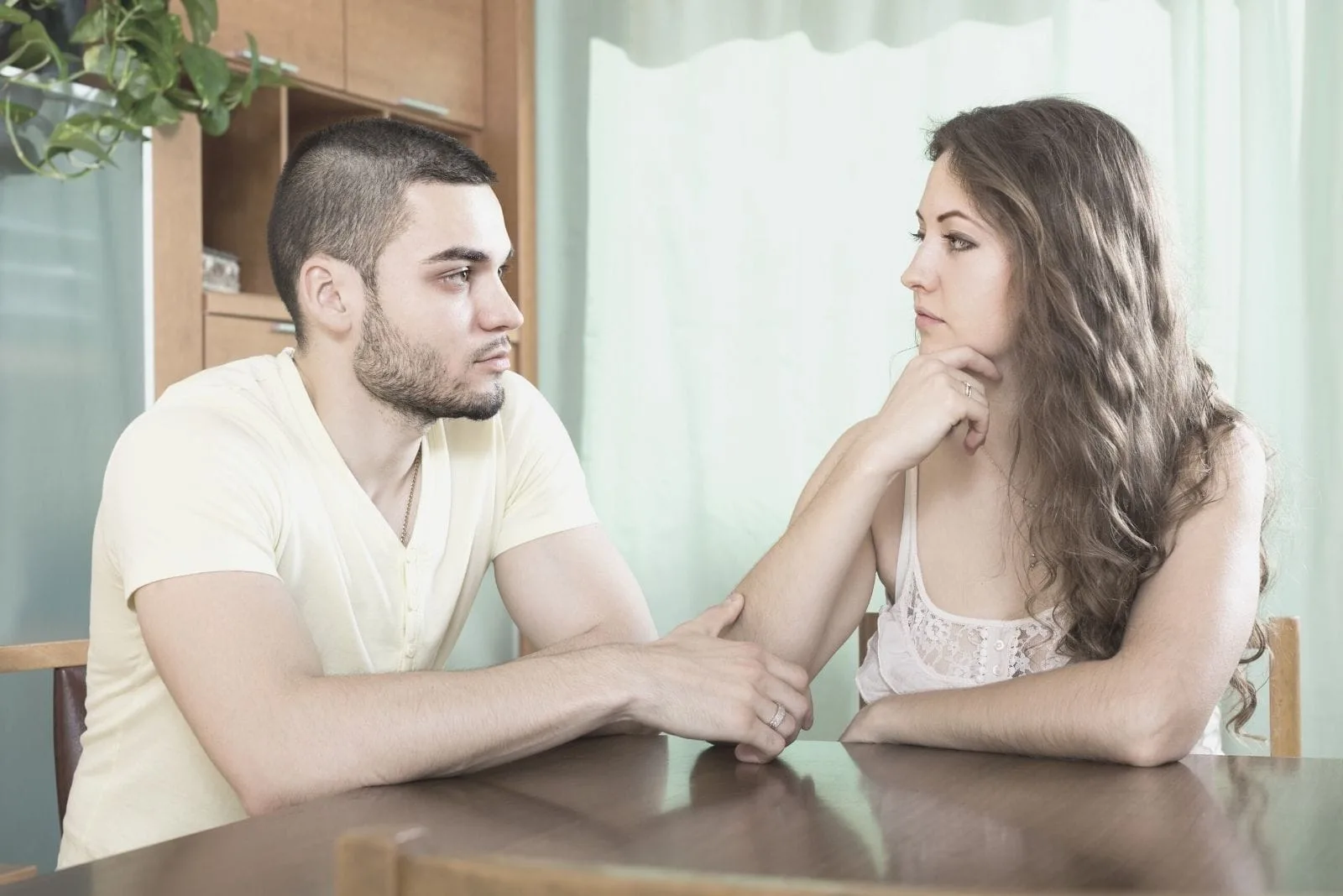 couple having serious talk inside dining room of the house