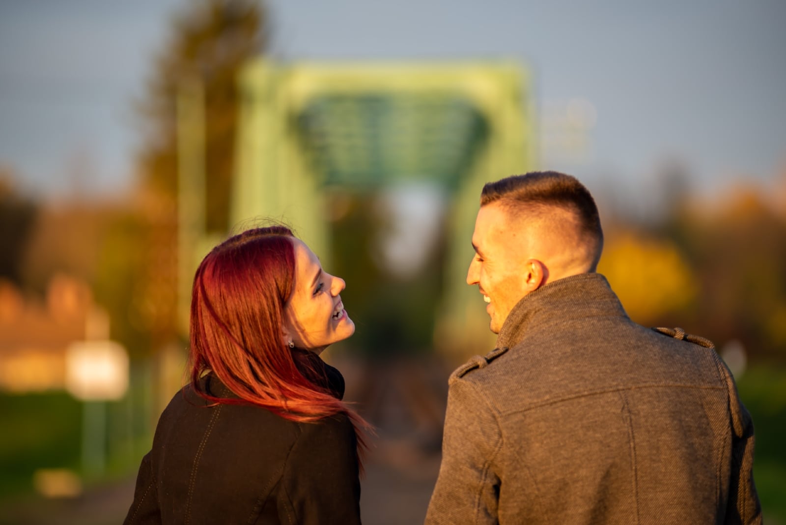 man and woman laughing while standing outdoor