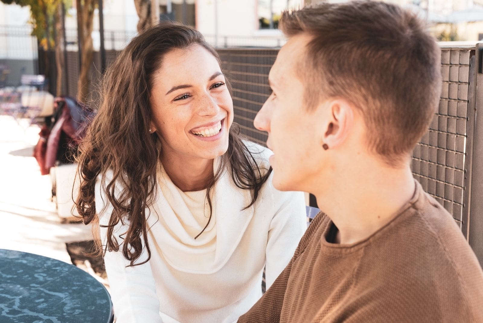 girl boy flirting in an outdoor cafe 