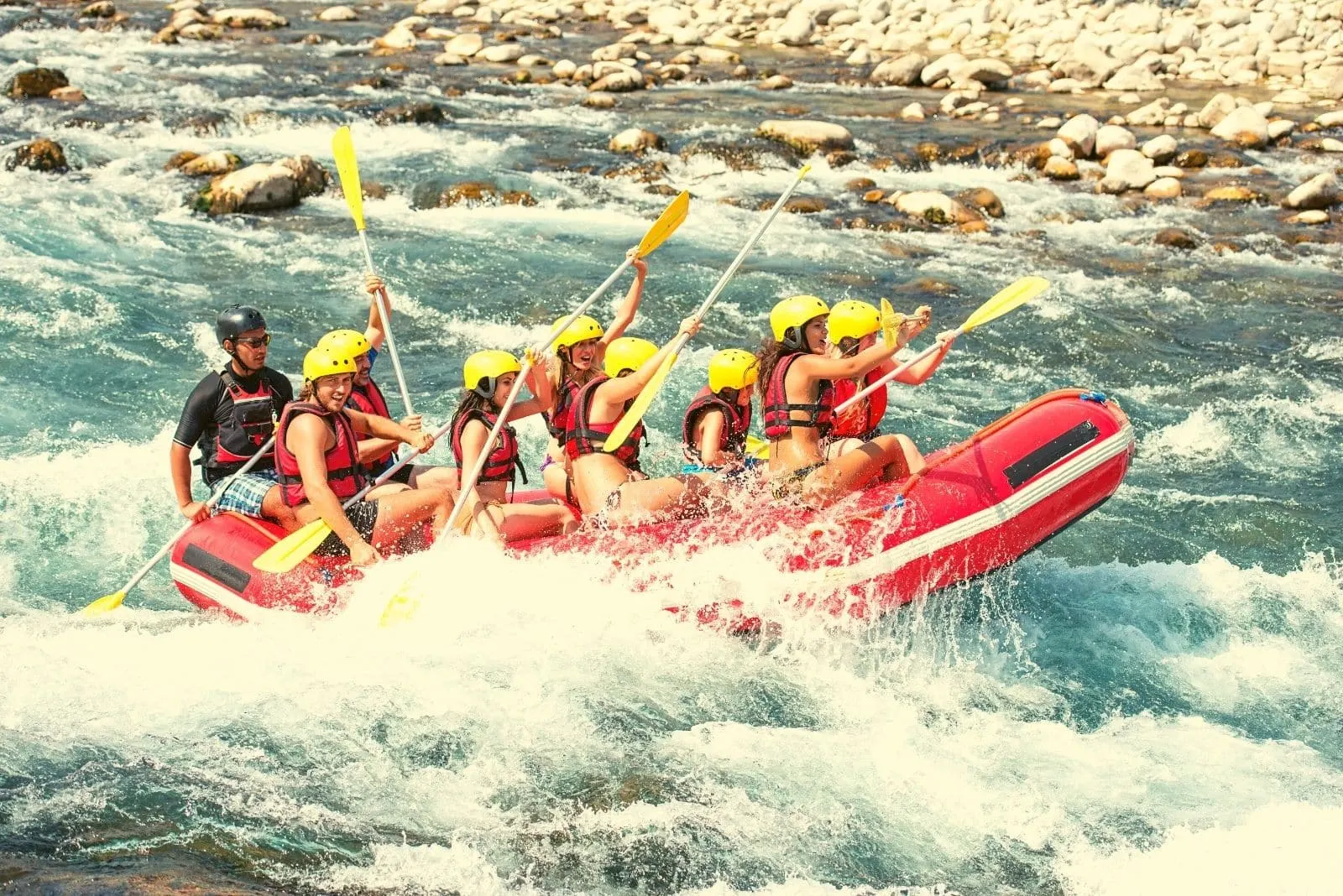 group of people enjoying the white water rafting in the river